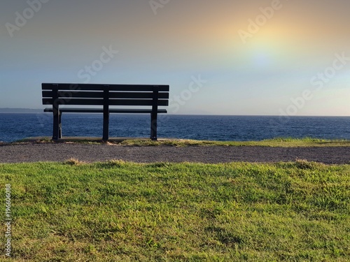 Single park bench on the horizon
