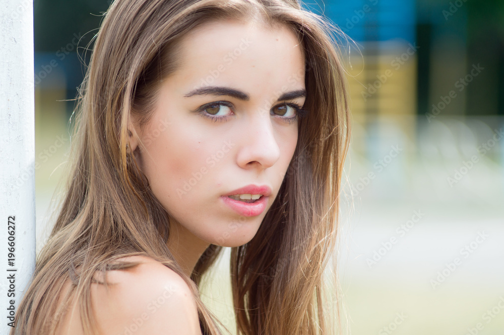 Portrait of a beautiful young woman model, close up in the yard Portrait of a beautiful young woman model, close up in the yard