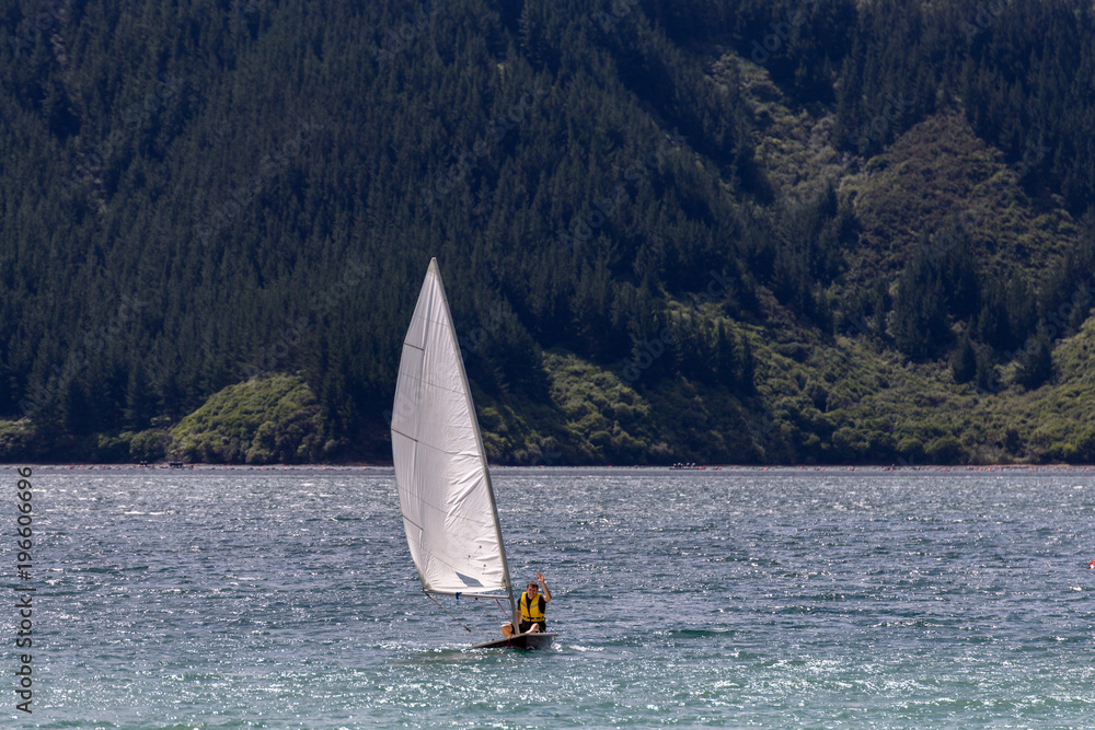 Obraz premium Young man on the sailing boat