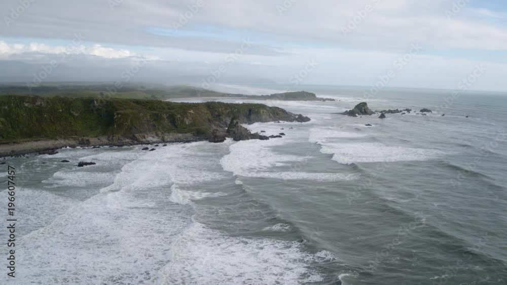 custom made wallpaper toronto digitalDrone shot of waves crashing into the west coast of New Zealand.