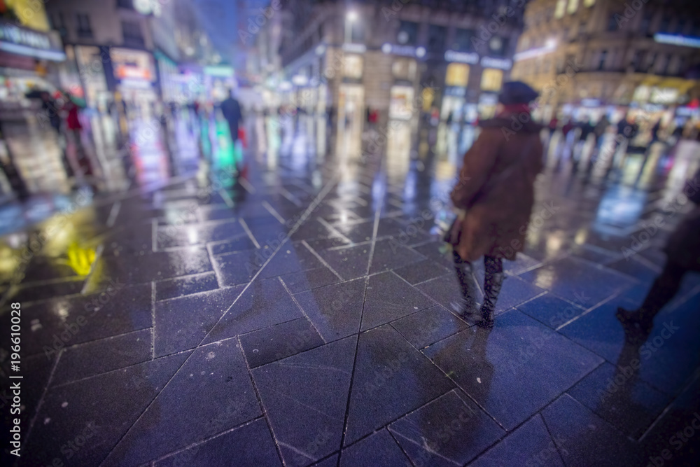 night and rainy city streets with people walking 