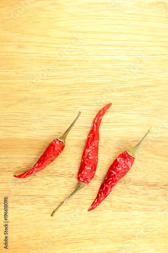 dried thai chili peppers on a wooden board with copyspace