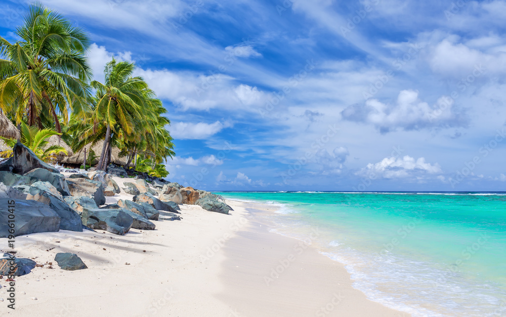 Stunning white sandy beach with rocks and palms on Rarotonga, Cook Islands Stunning white sandy beach with rocks and palms on Rarotonga, Cook Islands