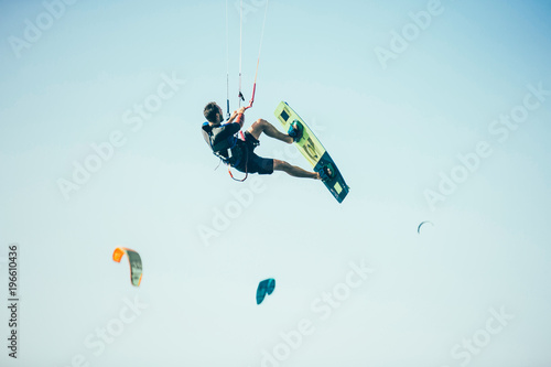 Kitesurfing Kiteboarding action photos man among waves quickly goes