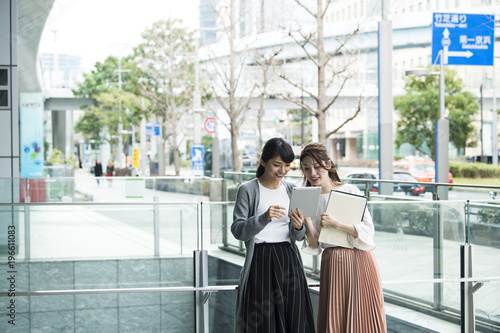 女性たちが楽しそうにタブレットを眺めている