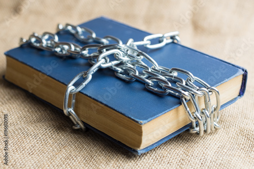 the book is chain-wound crosswise on a burlap of light brown color