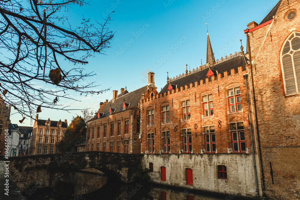 beautiful old traditional buildings and bridge over canal in brugge, belgium