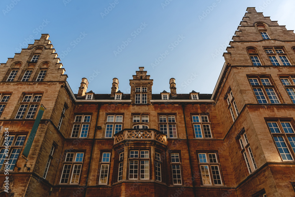 Fototapeta premium low angle view of beautiful old building and blue sky, Ghent, Belgium