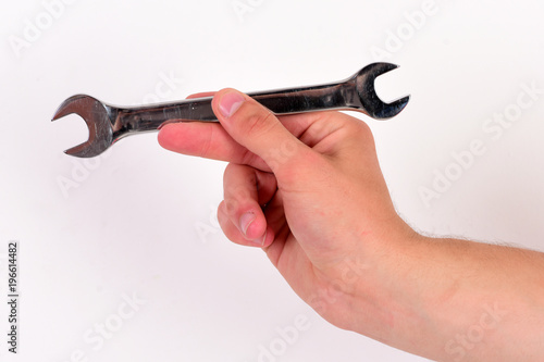 Wrench tool in male hand isolated on white background