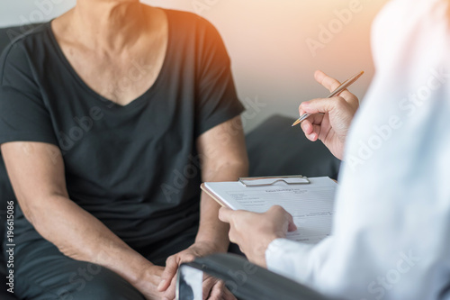 Geriatric doctor (geriatrician) consulting and diagnostic examining elderly senior adult patient (older person) on aging and mental health care in medical clinic office or hospital examination room