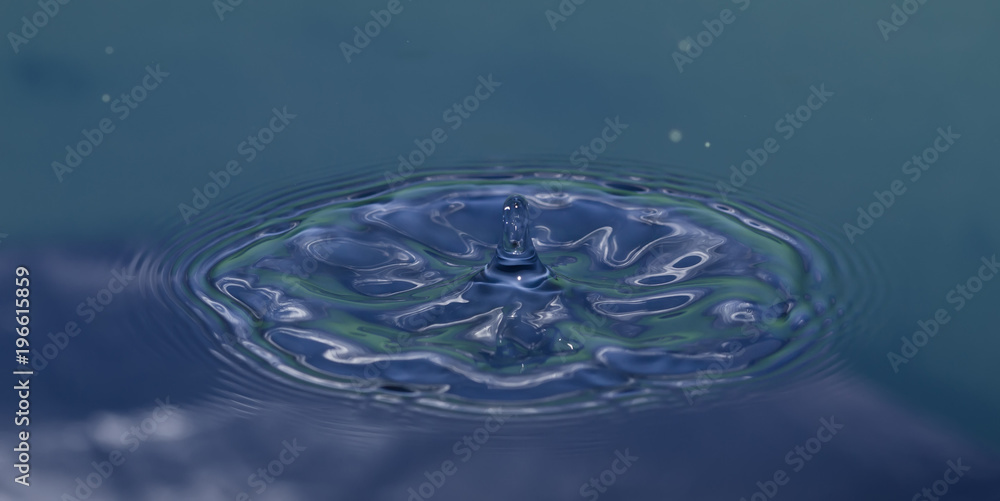drop of water liquid with splash isolated. the drop explodes in the water sending spray to the sides and circle ripples around it. the water is blue drop of water liquid with splash isolated. the drop explodes in the water sending spray to the sides and circle ripples around it. the water is blue