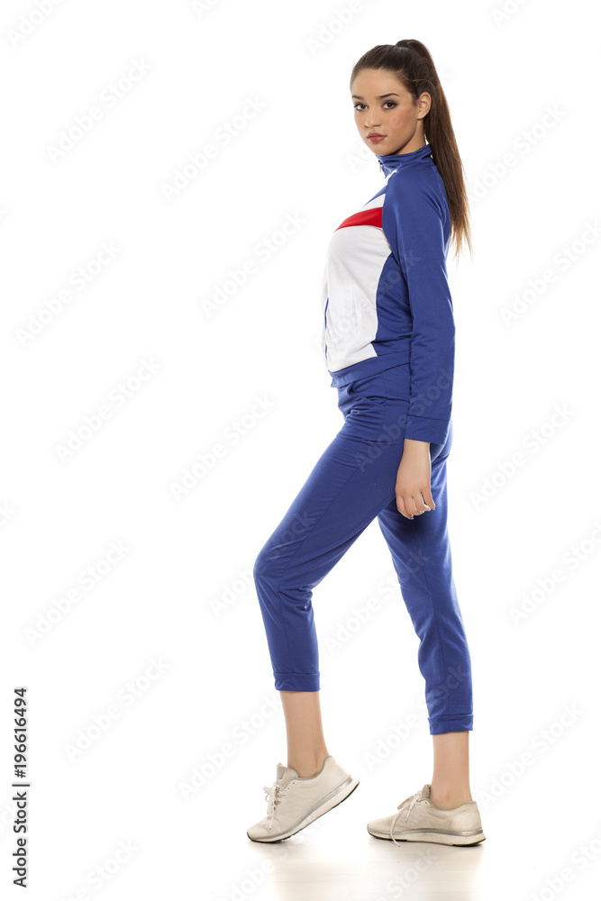 young women in blue tracksuits on a white background young women in blue tracksuits on a white background