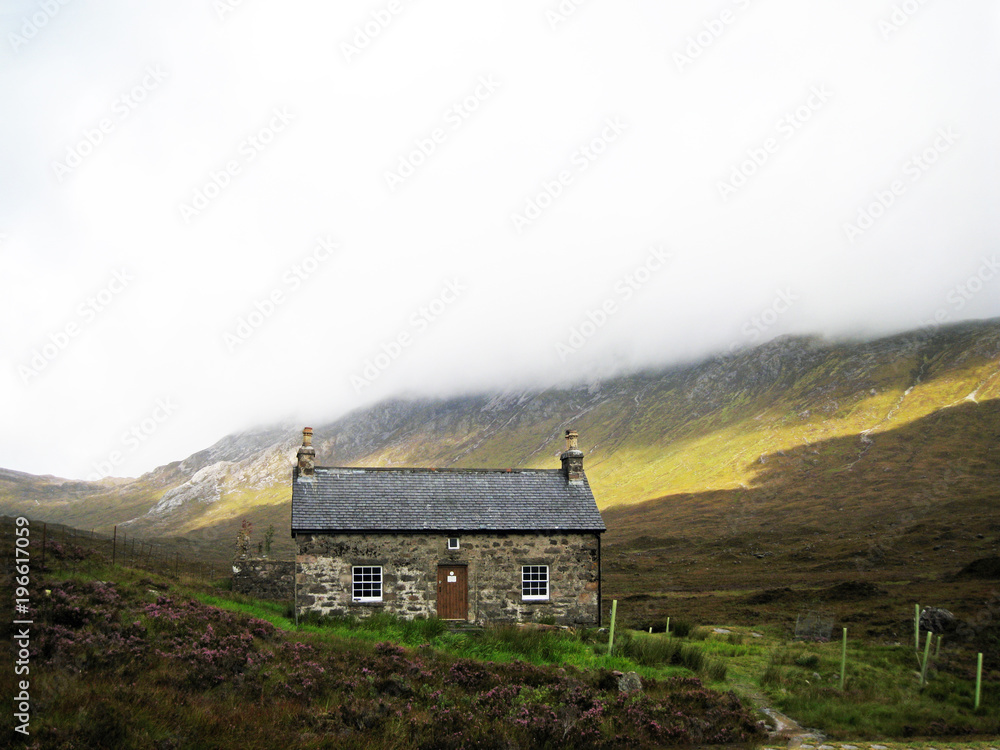 A welcoming looking Bothy on a typical highlands day with low cloud with some sunshine breaking through, in Torridon, Scotland A welcoming looking Bothy on a typical highlands day with low cloud with some sunshine breaking through, in Torridon, Scotland