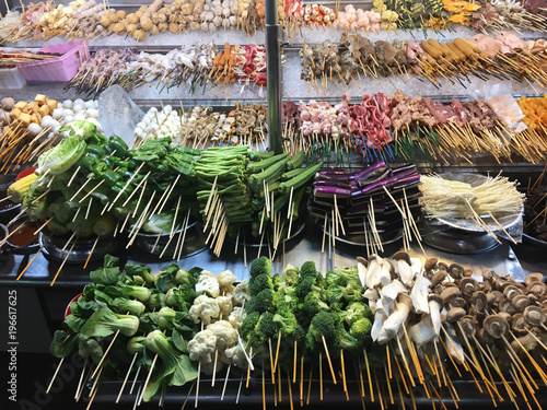Vast selection of fresh Lok Lok street food on stand in night market in Jalan Alor area of Kuala Lumpur, Malaysia