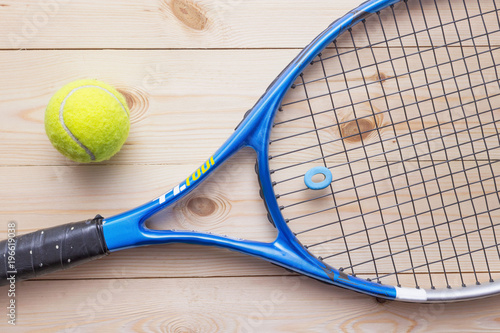 Tennis racket and ball on the wooden background top view © Станислав Сцепинский