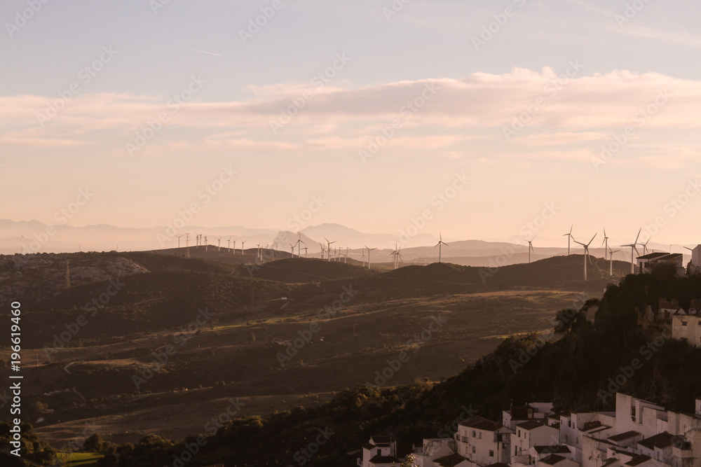 windmills in the mountains at sunset