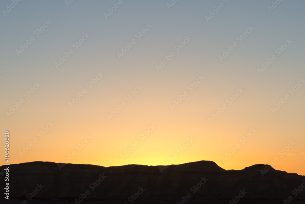 mountain silhouette in the Negev desert in Israel at sunset sunrise mountain silhouette in the Negev desert in Israel at sunset sunrise