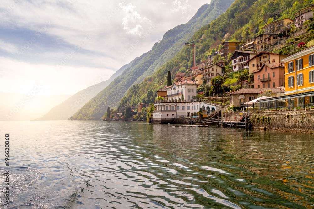 holidays in Italy - beautiful villages of Lake Como, spring time, overlooking a beautiful, calm lake, with antique buildings and alpine mountains in the background