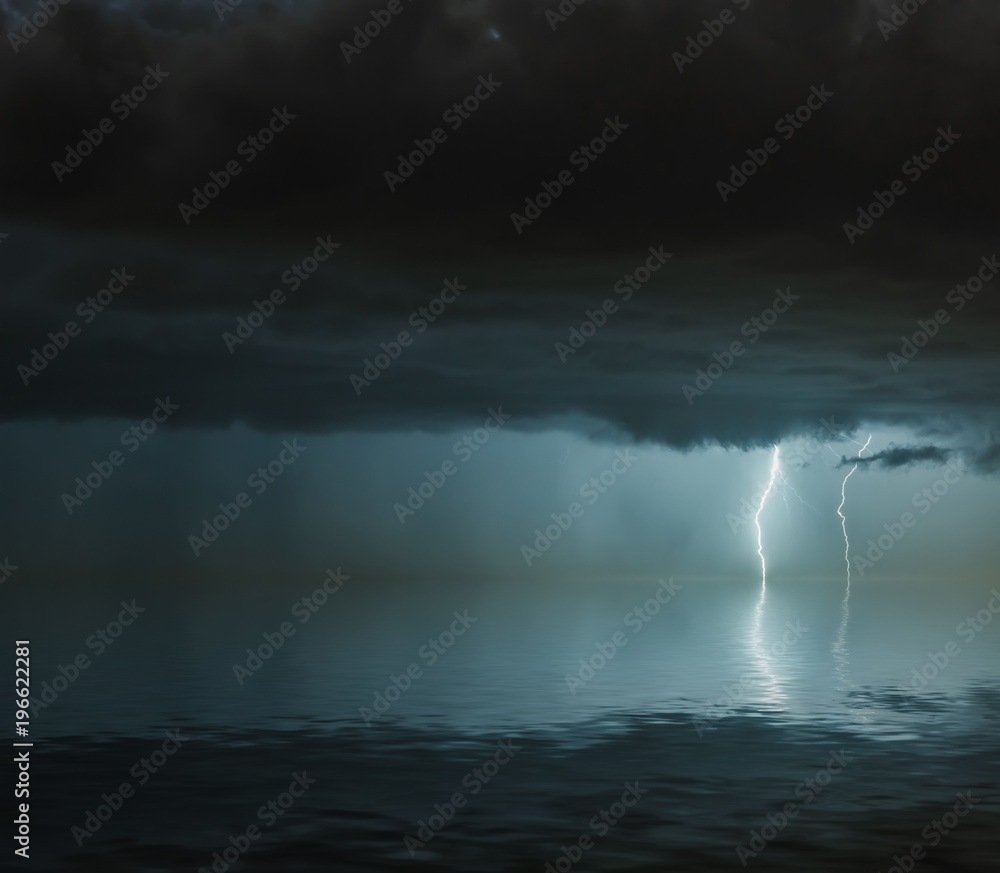 lightning bolts reflection over the sea. taken during a thunderstorm over the ocean with clouds in the background lightning bolts reflection over the sea. taken during a thunderstorm over the ocean with clouds in the background