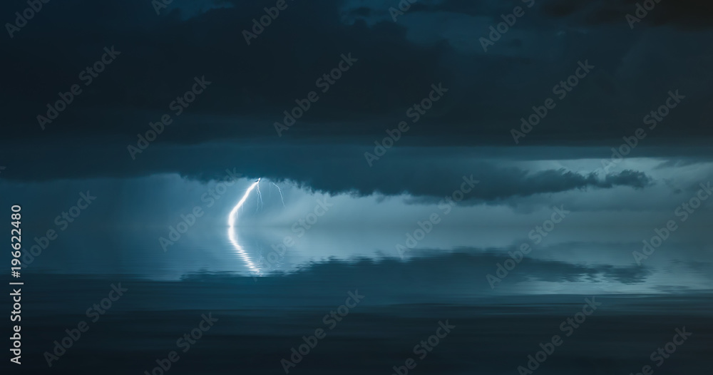 lightning bolts reflection over the sea. taken during a thunderstorm over the ocean with clouds in the background