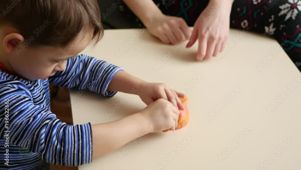 Children's creativity. The child and his mother mold figures from the ...