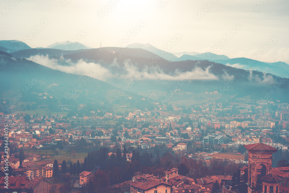 ancient bergamo overview with fog in the mountains