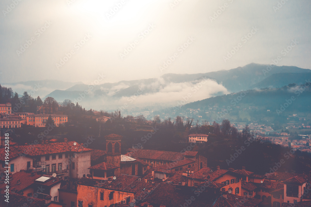 warm colored picture of city overview about bergamo, italy