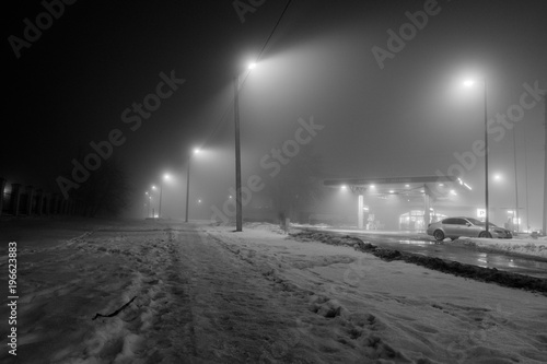 Gas station at foggy evening © Юрий Савицкий