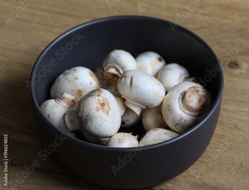 white button Common mushroom (Agaricus bisporus) on wooden table background