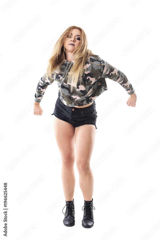 Passionate energetic jazz dancer dancing in military camouflage jacket with clenched fist. Full body isolated on white background. Passionate energetic jazz dancer dancing in military camouflage jacket with clenched fist. Full body isolated on white background.