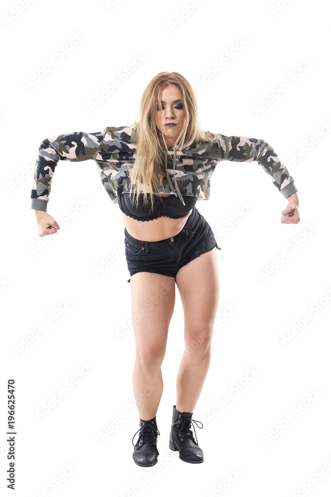 Energetic strong passionate female jazz dancer with clenched fist wearing military top dancing. Full body isolated on white background. Energetic strong passionate female jazz dancer with clenched fist wearing military top dancing. Full body isolated on white background.