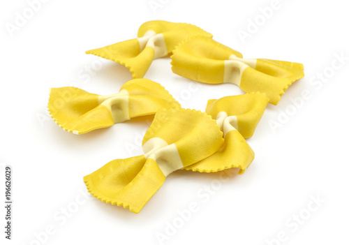 Farfalle pasta with curcuma isolated on white background five set raw classic traditional Italian yellow.