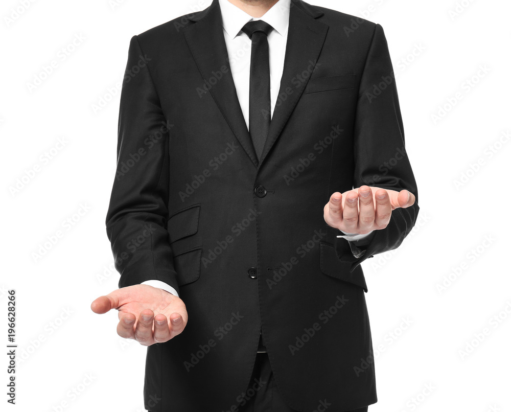 Young businessman showing balance gesture on white background Young businessman showing balance gesture on white background