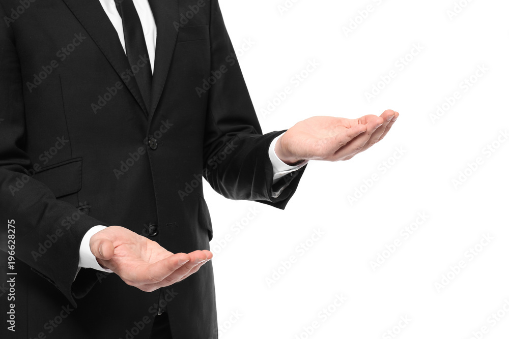 Young businessman showing balance gesture on white background Young businessman showing balance gesture on white background