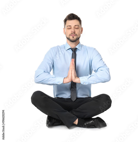 Young businessman meditatin...