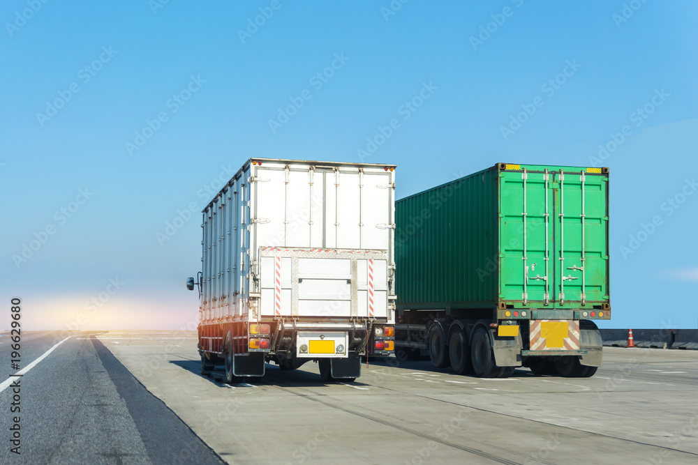 Truck on highway road with container, transportation concept.,import,export logistic industrial Transporting Land transport on the asphalt expressway with blue sky Truck on highway road with container, transportation concept.,import,export logistic industrial Transporting Land transport on the asphalt expressway with blue sky