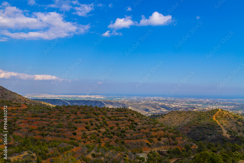 View from the mountains to the island of Cyprus, on a background of green forest and mountains