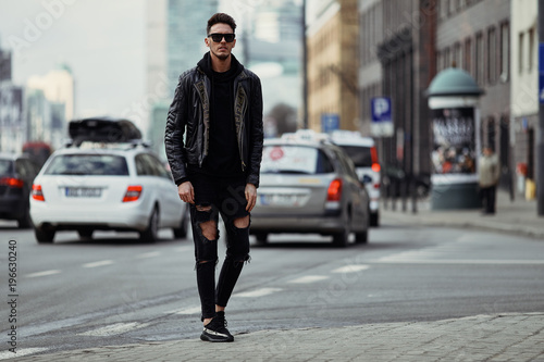 Model looking man stand on the city street with cars background, look on his watch and around © Serhiy Hipskyy