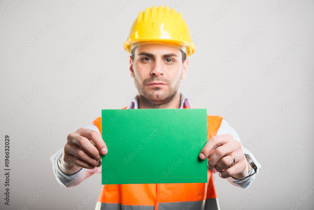 Selective focus of handsome architect holding green cardboard Selective focus of handsome architect holding green cardboard