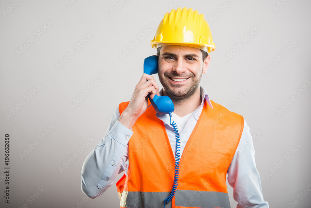 Portrait of handsome architect talking at telephone Portrait of handsome architect talking at telephone