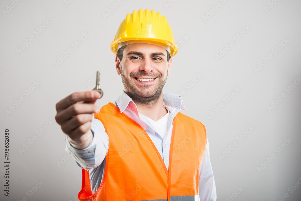 Portrait of handsome architect holding house key Portrait of handsome architect holding house key