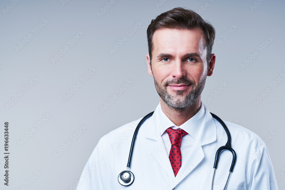 Portrait of male doctor isolated on grey background Portrait of male doctor isolated on grey background