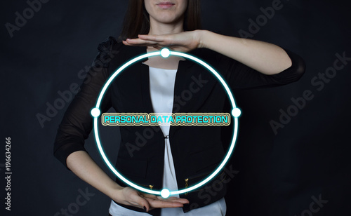 In the hands of a businessman  a neon circle with the inscription PERSONAL DATA PROTECTION