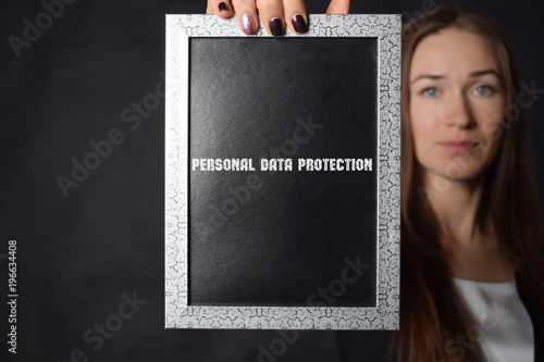 In the hands of a businessman a frame with the inscription:PERSONAL DATA PROTECTION