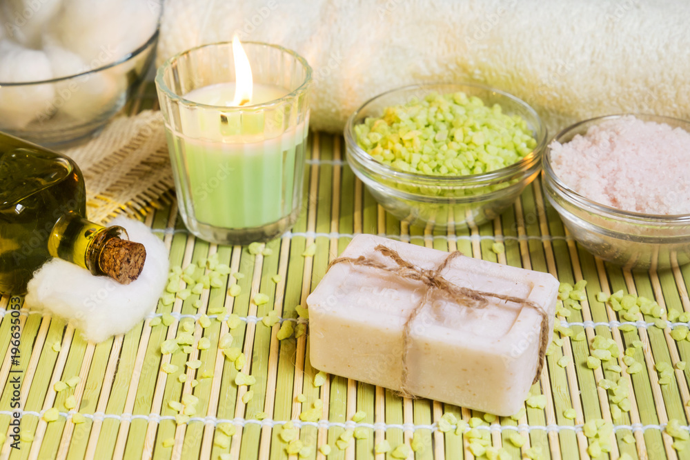 Spa setting with natural soap, olive oil, bath salts and candle. Wellnes concept. Spa setting with natural soap, olive oil, bath salts and candle. Wellnes concept.