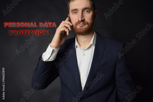 A businessman shows an inscription:PERSONAL DATA PROTECTION