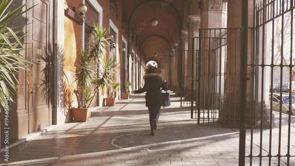 portrait of young woman runs under the arches in the city portrait of young woman runs under the arches in the city