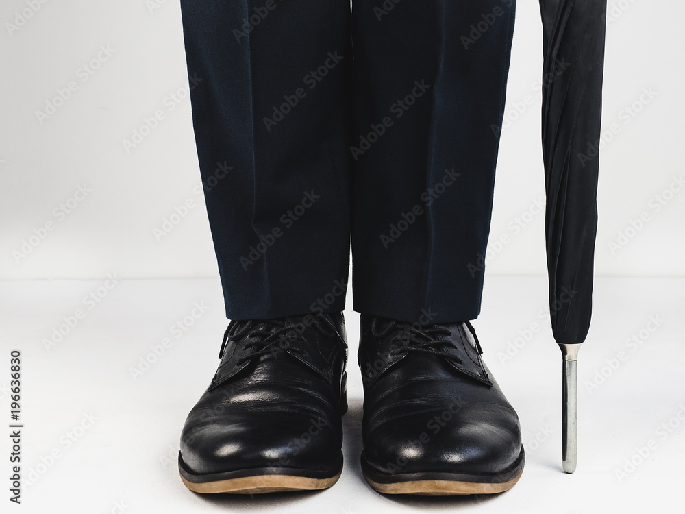 Stylish, black shoes and umbrella on a white background. Style, fashion, beauty Stylish, black shoes and umbrella on a white background. Style, fashion, beauty