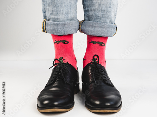 Stylish, vintage shoes, bright, funny socks with a pattern and men's legs on a white background. Style, fashion, beauty, mood