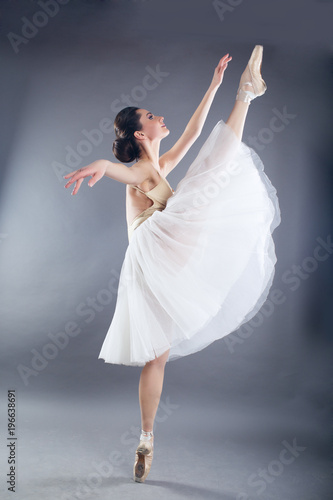 Beautiful slim woman ballet dancer in studio